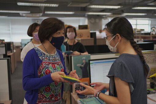 Dr. Kenneth Tse, Chairman of the Foundation, and two school Supervisors distribute the reusable face masks to College staff