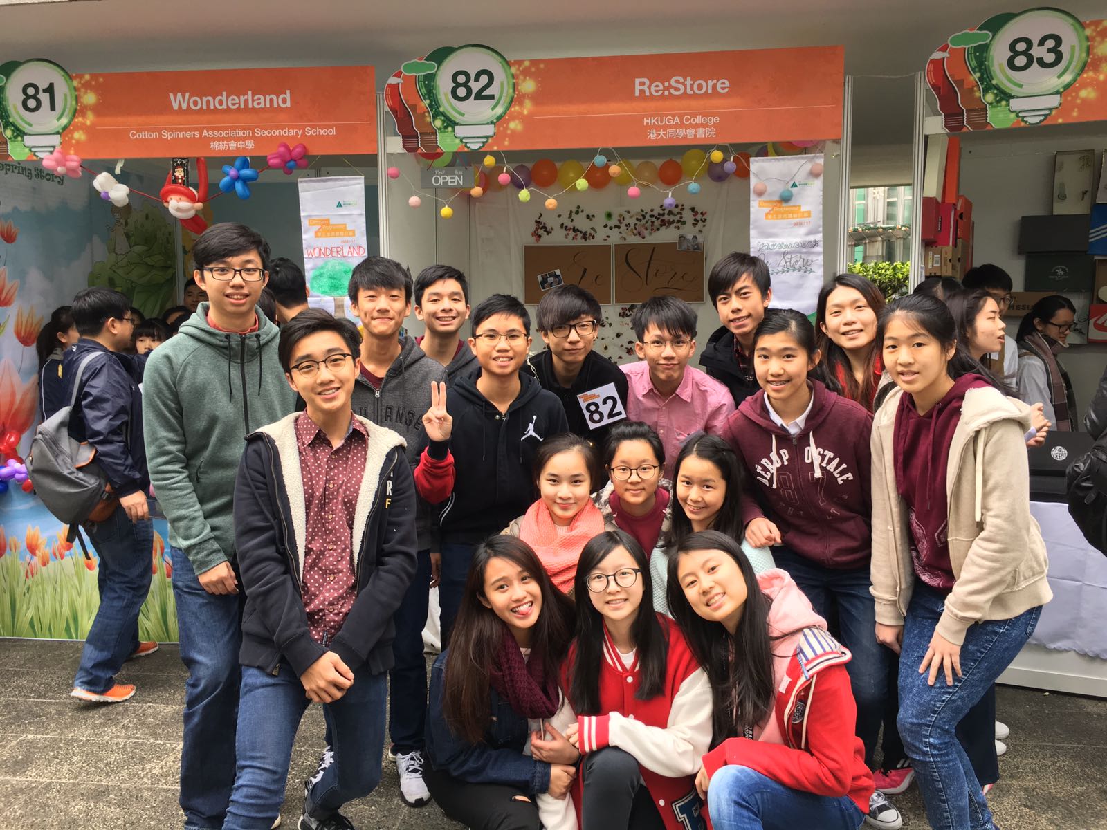 Group photo of participated students in front of the booth.